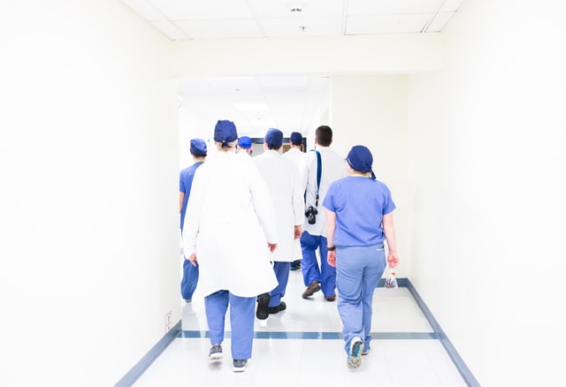 surgeons standing around operating table