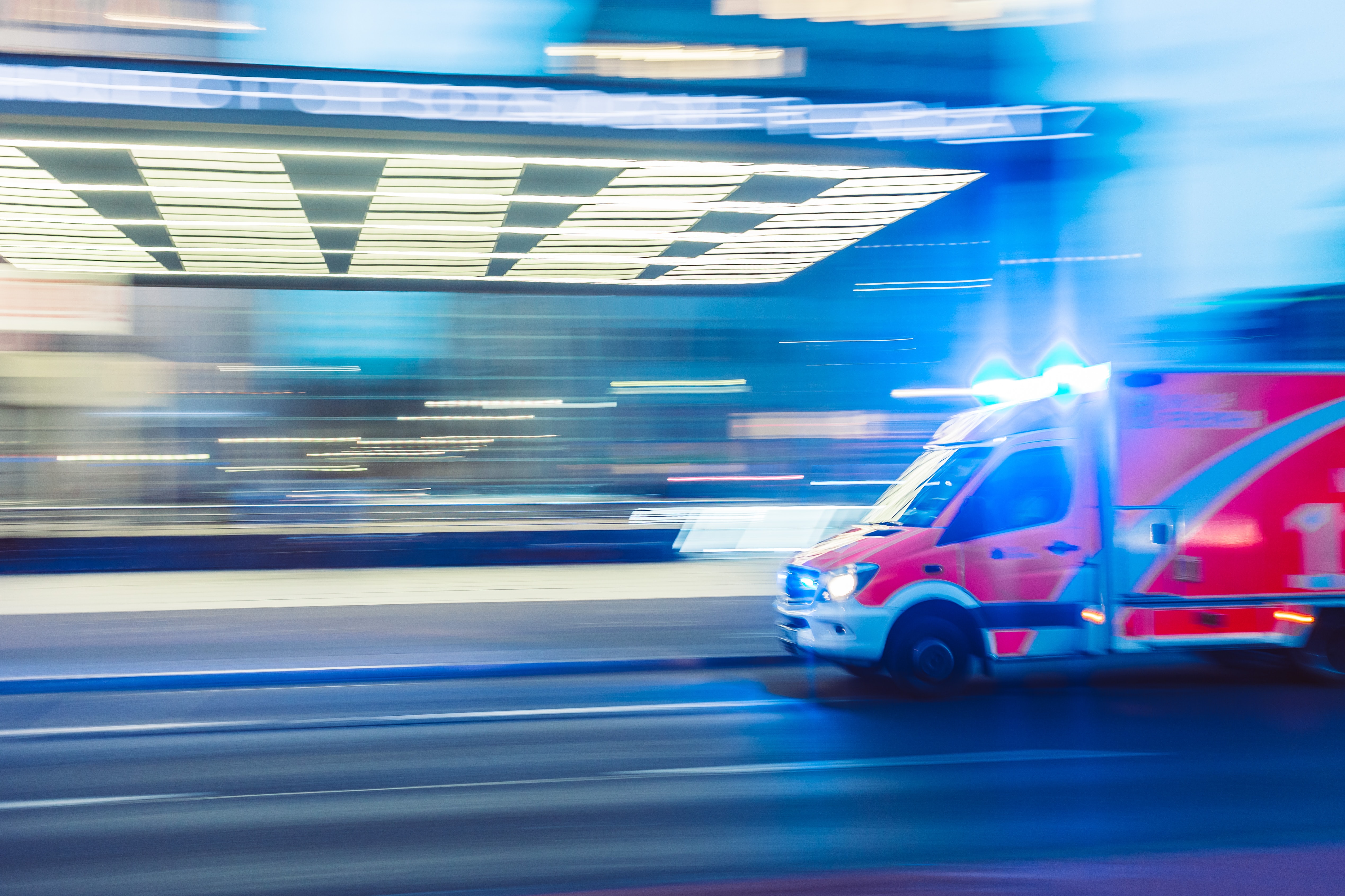 an ambulance with lights going and motion blur
